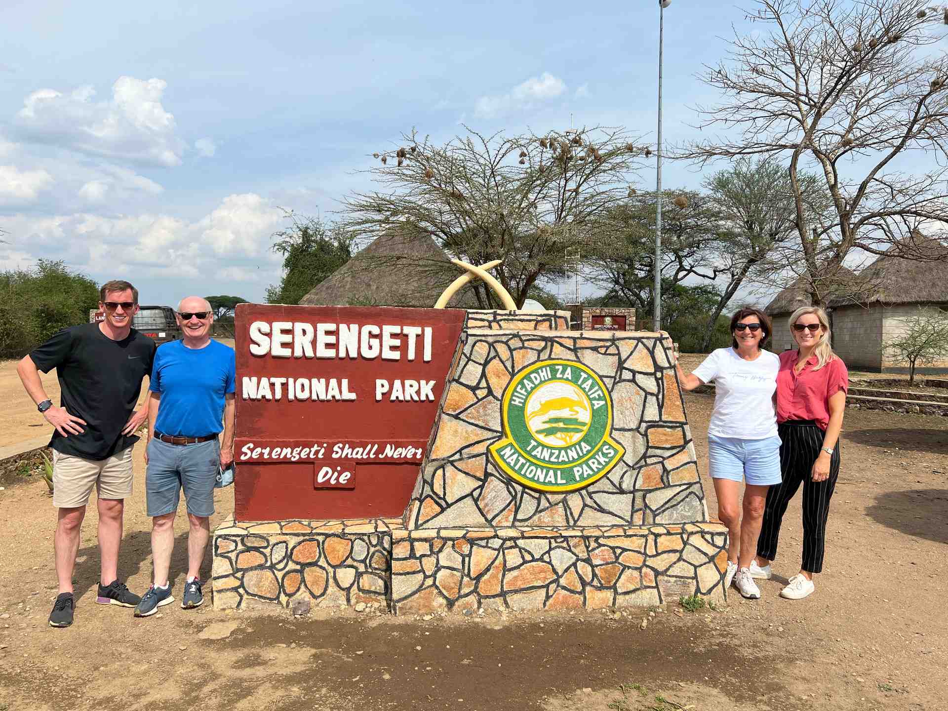 David Simpson, mom, dad and sister at Serengeti entrance in Tanzania. The Serengeti