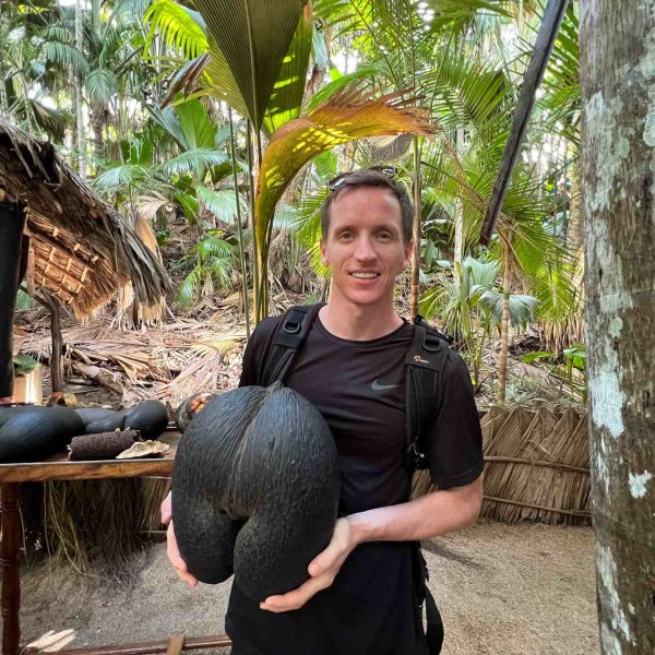David Simpson holding palm fruit at Vallée De Mai in Seychelles. Seychelles, Vallée De Mai and Anse Lazio