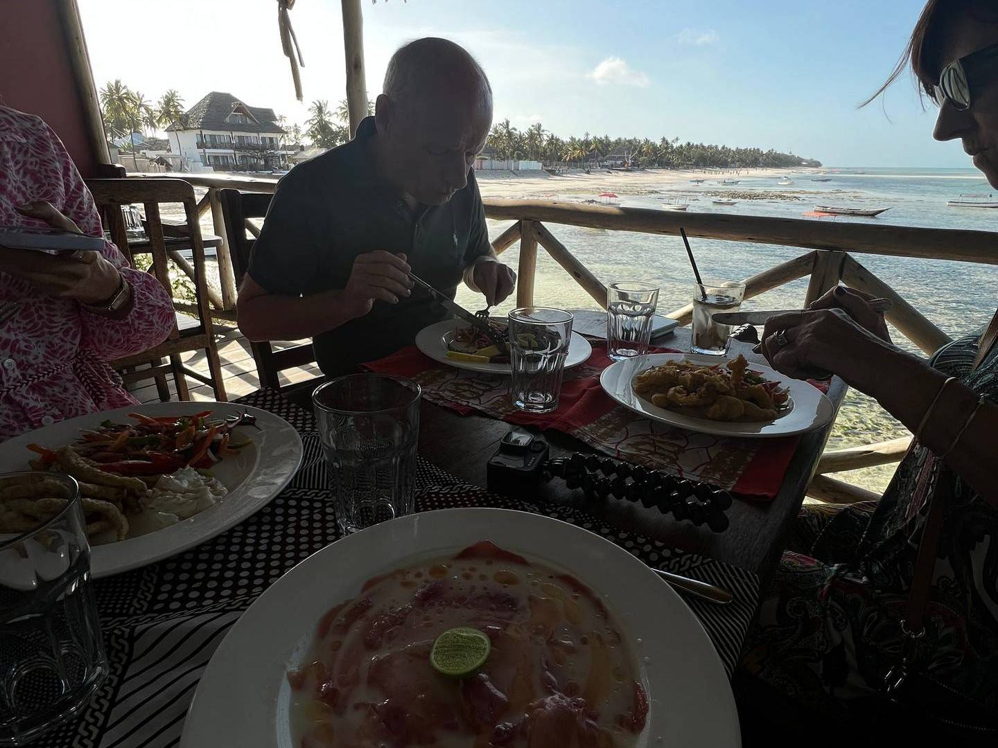 Dad eating at The Rock Restaurant in Zanzibar, Tanzania. Worst food with the best view at the Rock, Zanzibar