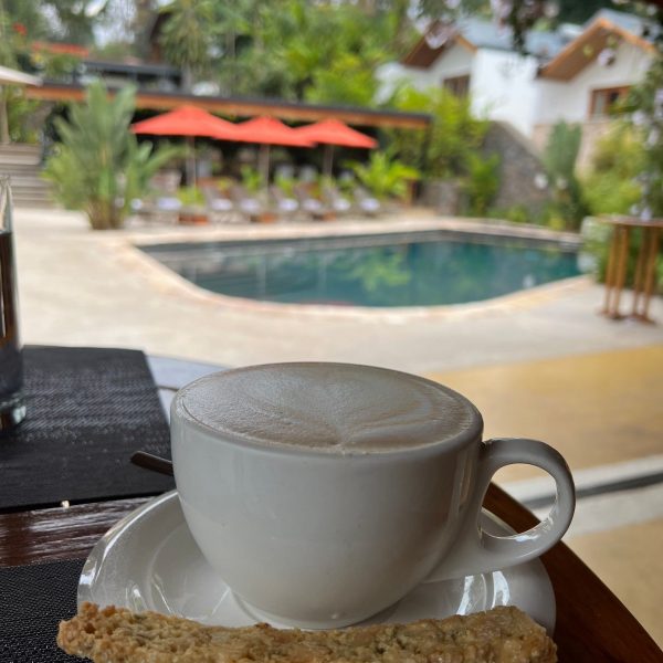 Cup of coffee by the pool in Retreat Hotel in Kigali, Rwanda. The Rwandan genocide & a toothache