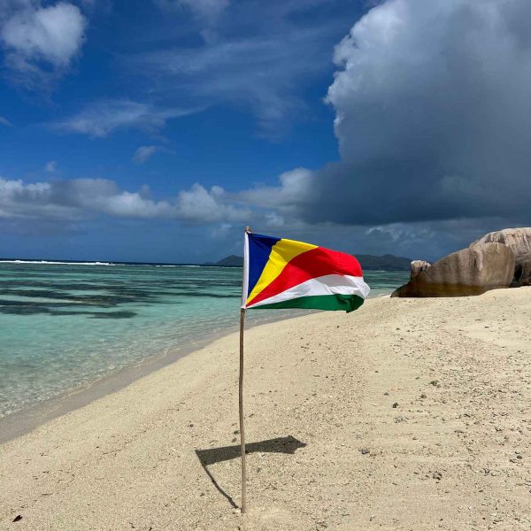 Flag at beach in Anse Source D_Argent, Seychelles. The best beach in the World & rip drone