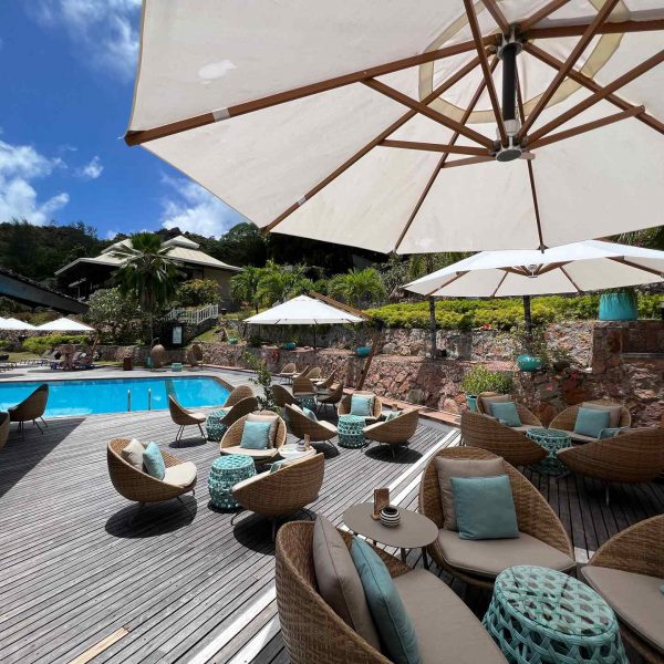 Umbrellas and chairs by the pool in Seychelles. Seychelles, Vallée De Mai and Anse Lazio