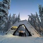 David Simpson and family at entrance arch of resort in Saariselka, Finland. The Lapland Series reflection post
