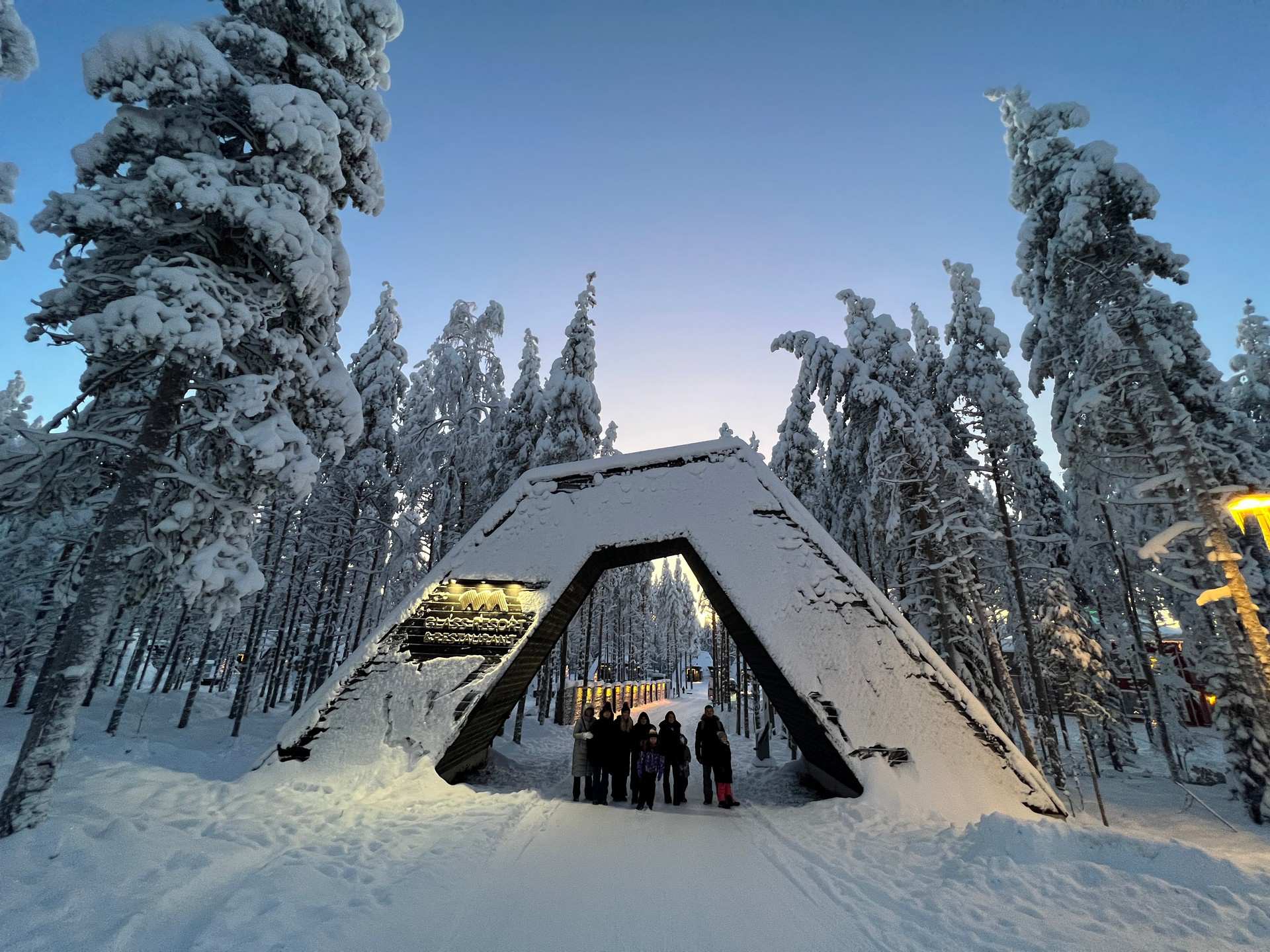 David Simpson and family at entrance arch of resort in Saariselka, Finland. The Lapland Series reflection post