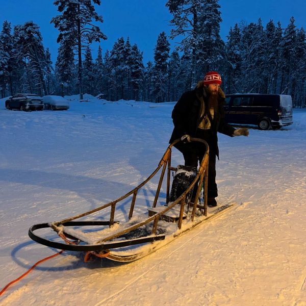 Driver on sled in Saariselka, Finland. Frozen karting & husky rides