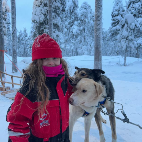 Niece and huskies in Rovaniemi, Finland. Christmas Day in Lapland