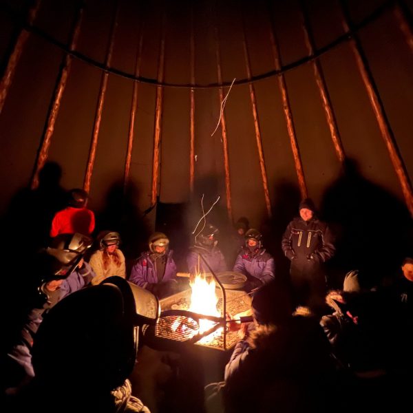 People around the campfire in Ivalo, Finland. The truth about Kakslauttanen Arctic resort