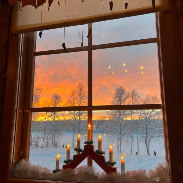 Candles by the window of a house in Rovaniemi, Finland. Christmas Day in Lapland