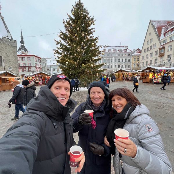David Simpson with mom and dad and Christmas tree at the market in Tallinn, Estonia. Day trip to magical Tallinn