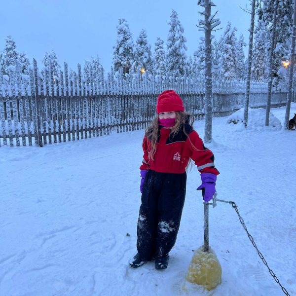 Niece standing in the snow in Rovaniemi, Finland. Christmas Day in Lapland