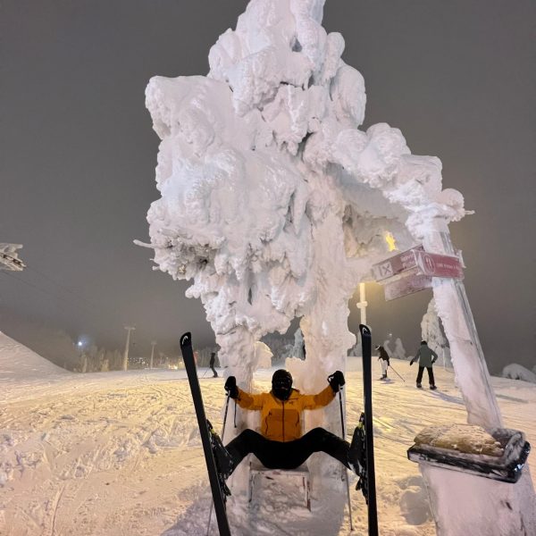 Skier seated in Ruka, Finland. Reindeer yoga, vengeance & NYE