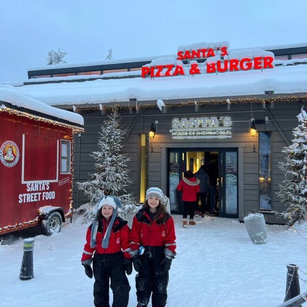 Nieces standing outside the restaurant in Rovaniemi, Finland. Christmas Day in Lapland
