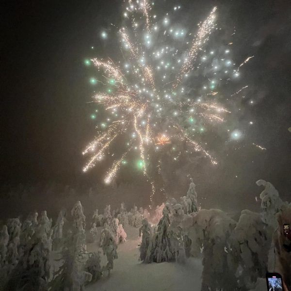 Fireworks over the snow covered trees in Ruka, Finland. Reindeer yoga, vengeance & NYE