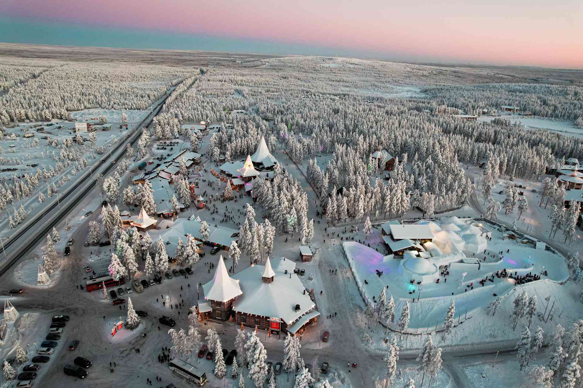 Aerial view of snow covered trees and houses in Rovaniemi, Finland. Christmas Day in Lapland