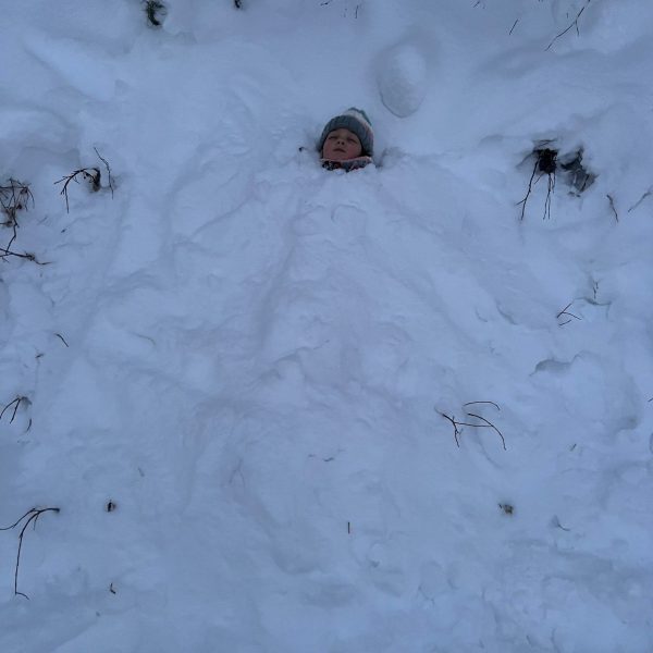 Snow buried niece in Rovaniemi, Finland. Christmas Day in Lapland