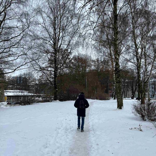 Person walking on the snow in Tallinn, Estonia. Day trip to magical Tallinn