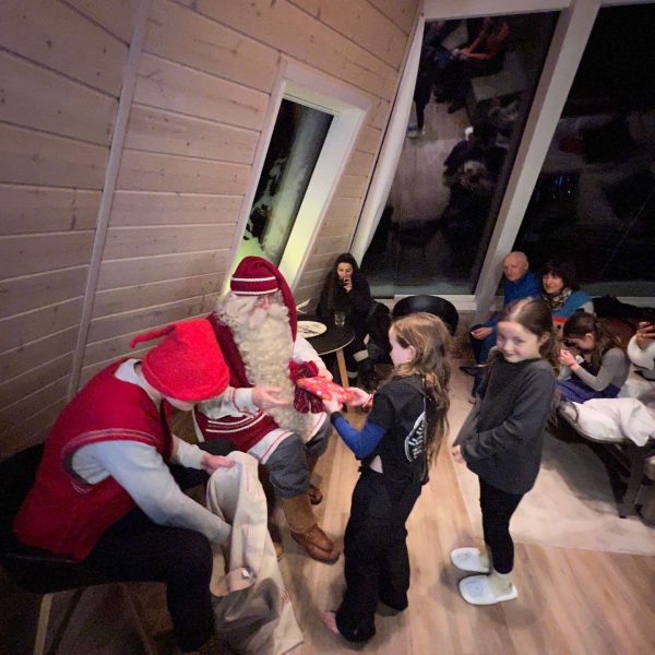 Santa giving gifts to nieces in Saariselka, Finland. Arriving in Santa Claus Village