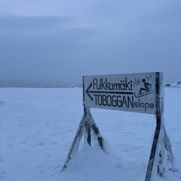 Toboggan sign in Saariselka, Finland. Jumping in an ice lake with mum & dad