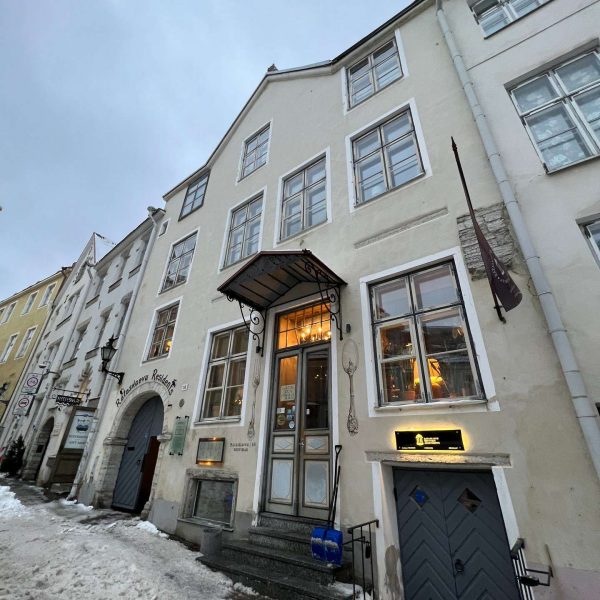 Buildings and entrance of restaurant in Tallinn, Estonia. Day trip to magical Tallinn