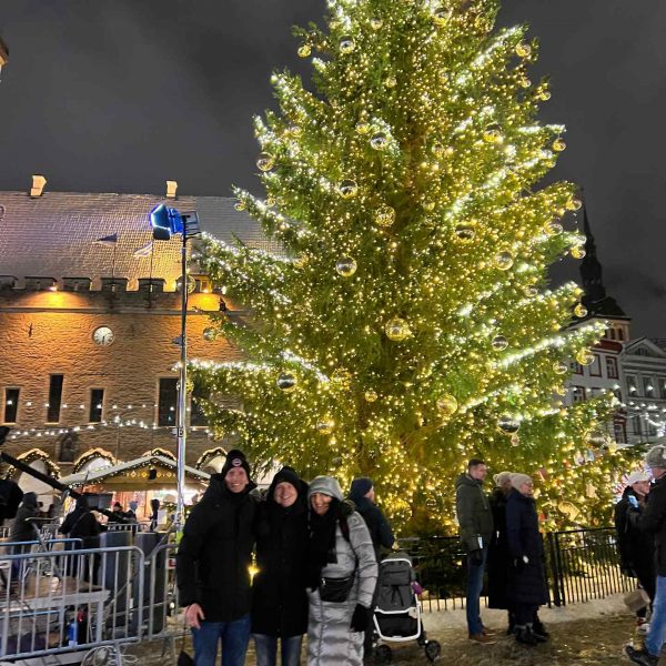 David Simpson with mom and dad and Christmas tree at the market in Tallinn, Estonia. Day trip to magical Tallinn