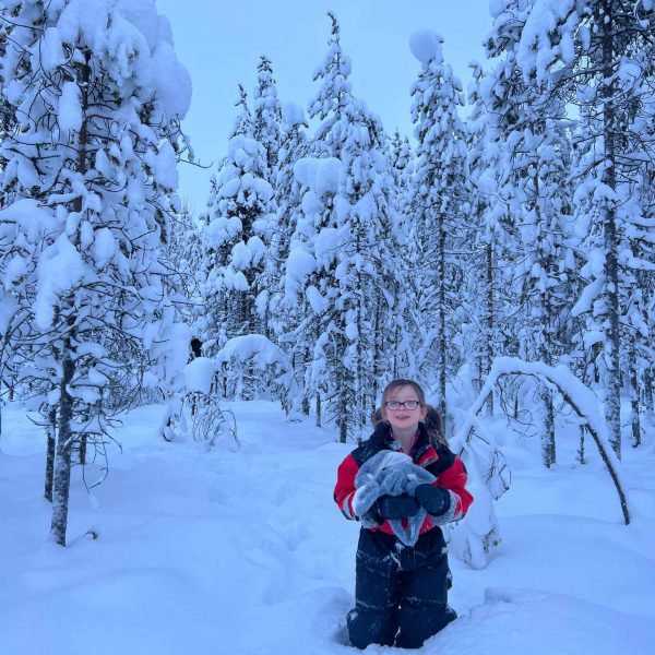 Niece standing in the snow in Rovaniemi, Finland. Christmas Day in Lapland