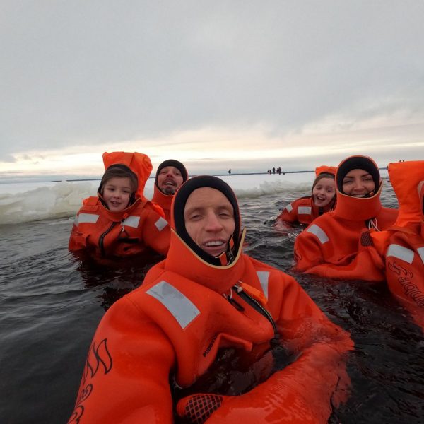 David Simpson and nieces floating in water in Kemi, Finland. The Polar Explorer Icebreaker, Sweden