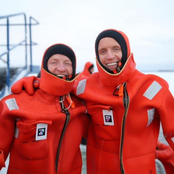 Davis Simpson and dad wearing dry suits aboard the ice breaker in Kemi, Finland. The Polar Explorer Icebreaker, Sweden