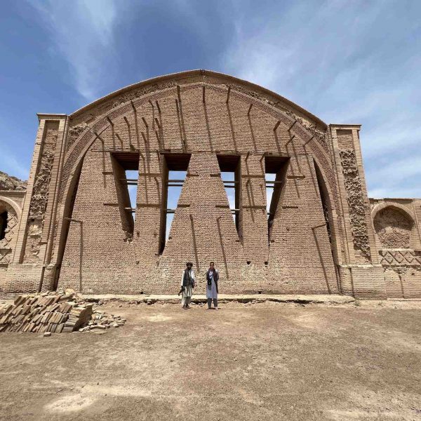 David Simpson and local guy standing near arch in Herat, Afghanistan. Flour mill, super noodles and the Afghan Ring road