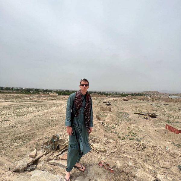 David Simpson standing in Ghazi, Afghanistan. Sandstorm, bricks & cramps; Kabul to Kandahar