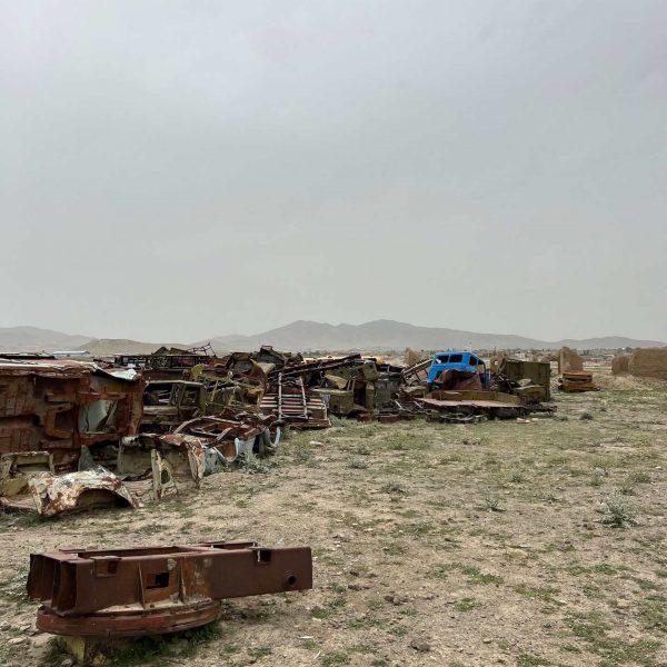 Junkyard of war relics in the desert in Ghazi, Afghanistan. Sandstorm, bricks & cramps; Kabul to Kandahar