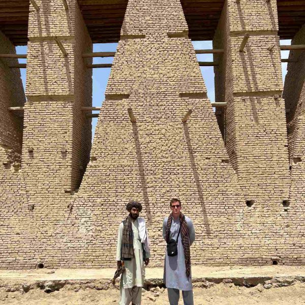 David Simpson and local guy standing near arch in Herat, Afghanistan. Flour mill, super noodles and the Afghan Ring road
