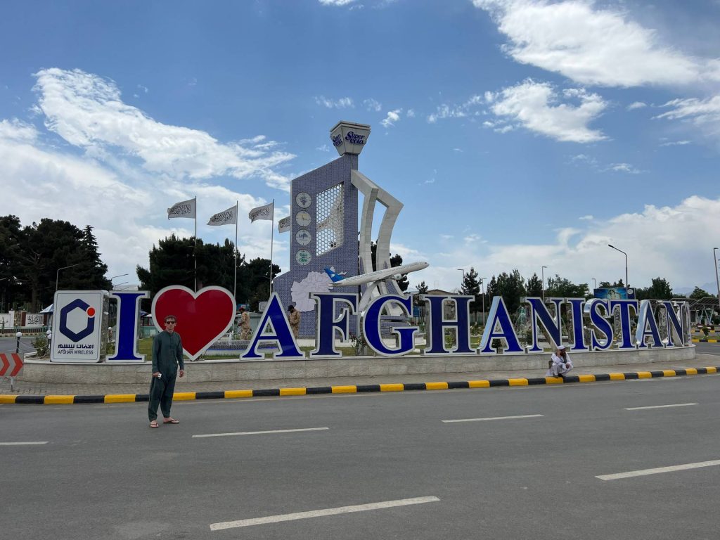 David Simpson and Afghanistan sign at airport in Herat, Afghanistan. Camels, rolling & sleep ‘n fly