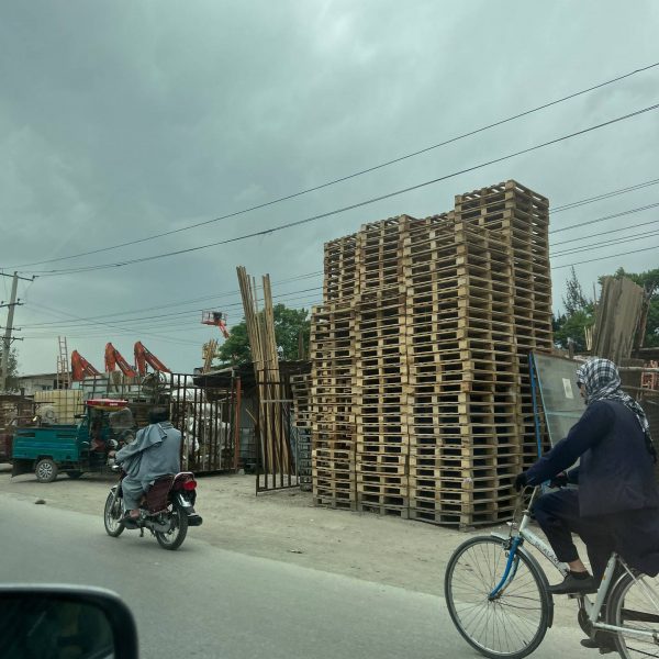 Local people passing by wooden pallets in Jalalabad, Afghanistan. Worst food poisoning, Jalalabad