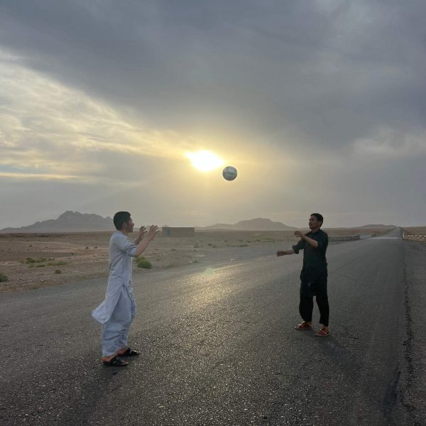 Local guys playing with ball in Herat, Afghanistan. Flour mill, super noodles and the Afghan Ring road
