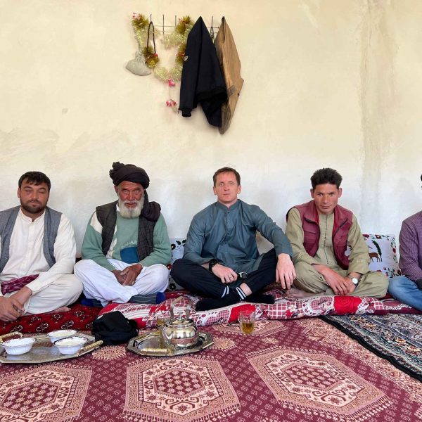 David Simpson seated with the local men in Bamiyan, Afghanistan. Bamiyan, Qlukhi & The Buddhas