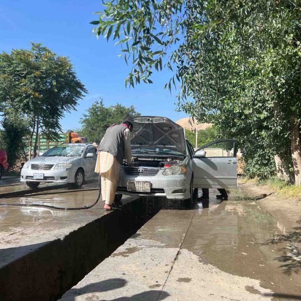 Local guy washing car in Mazar, Afghanistan. Body search, Soviet exploits & The Salang Pass
