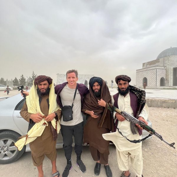 David Simpson with Taliban in Kabul, Afghanistan. Crazy friday flag with Afghan locals