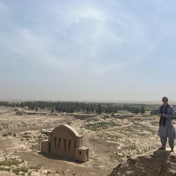 David Simpson and arch in desert in Herat, Afghanistan. Flour mill, super noodles and the Afghan Ring road
