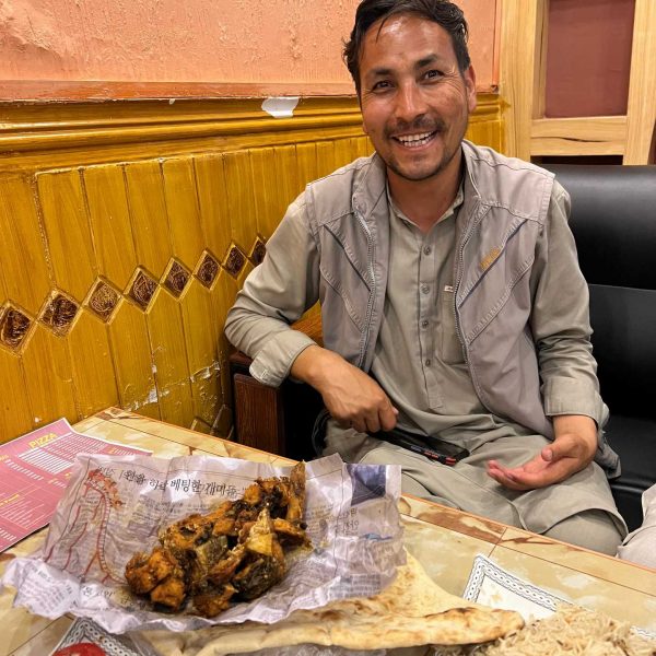 Local guy eating at restaurant in Jalalabad, Afghanistan. Worst food poisoning, Jalalabad