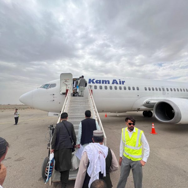 Passengers boarding plane at airport in Herat, Afghanistan. Camels, rolling & sleep ‘n fly