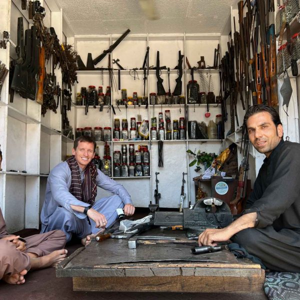 David Simpson with local people at gun shop in Jalalabad, Afghanistan. Worst food poisoning, Jalalabad