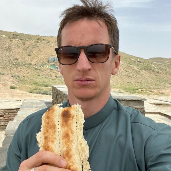David Simpson eating bread in Ghazi, Afghanistan. Sandstorm, bricks & cramps; Kabul to Kandahar