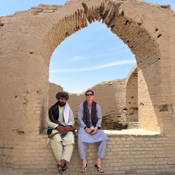David Simpson and local guy sitting in the shade in Herat, Afghanistan. Flour mill, super noodles and the Afghan Ring road