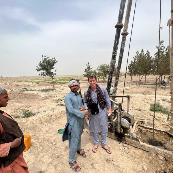 David Simpson and local well diggers in Mazar, Afghanistan. Playing volley ball with the Taliban