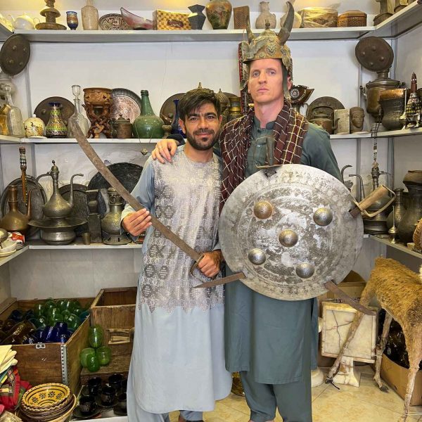 David Simpson and local shopkeeper at antique shop in Herat, Afghanistan. Camels, rolling & sleep ‘n fly