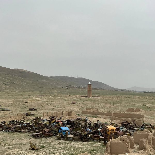 Junkyard of war relics in the desert in Ghazi, Afghanistan. Sandstorm, bricks & cramps; Kabul to Kandahar