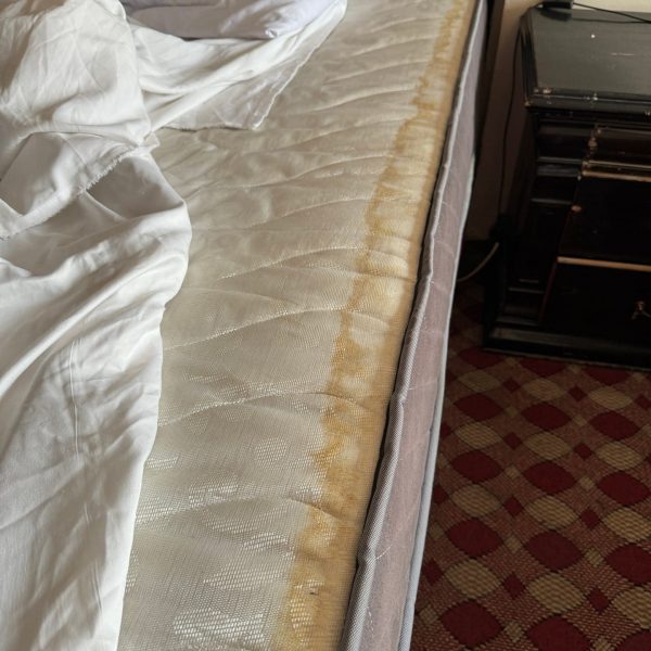 Stained bed at the hotel in Iraq. Iraqi sleeper train
