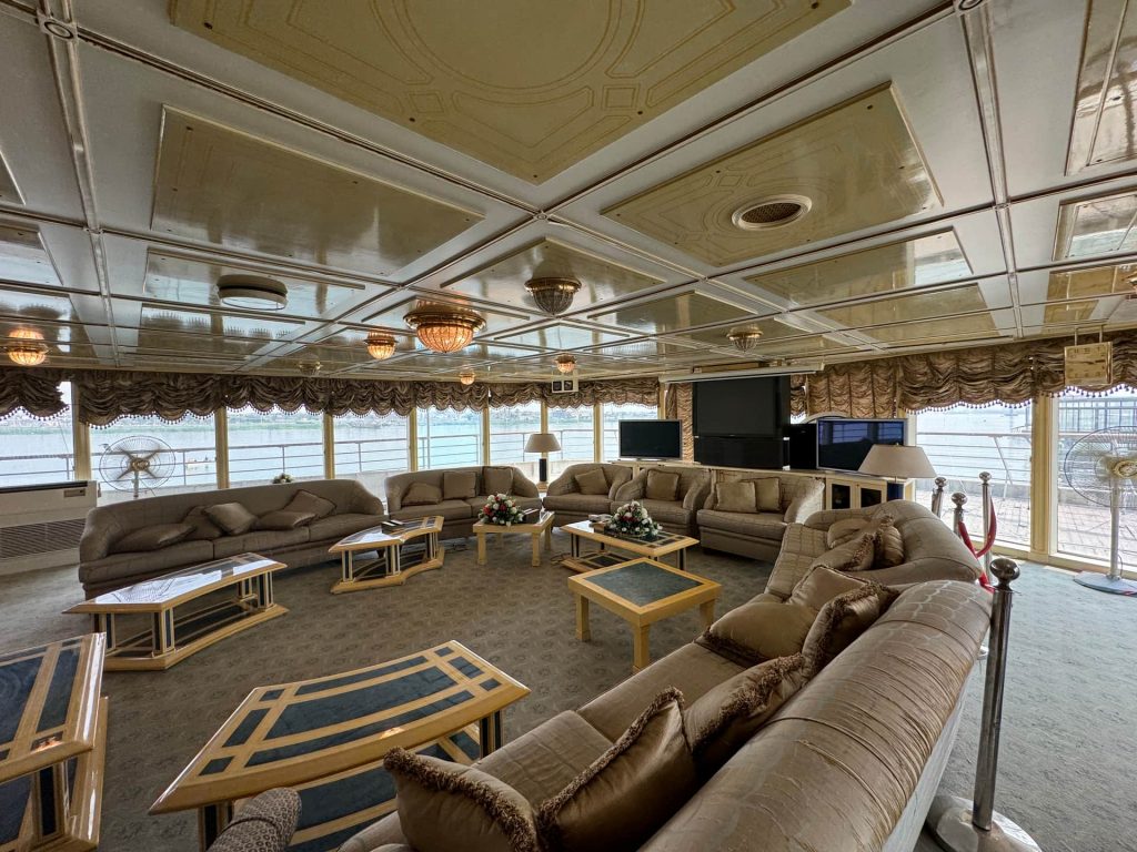 Large lounge area of Basrah Breeze in Iraq. Private tour of Saddam's yacht