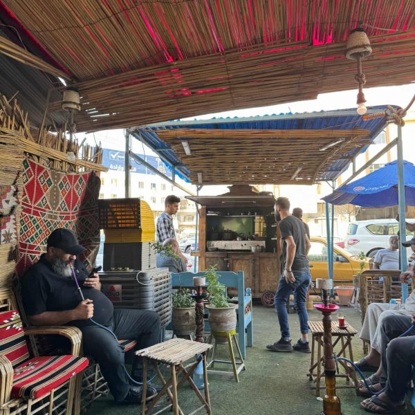 Locals seated having shisha in Iraq. A tour around Baghdad & the Al Anbar