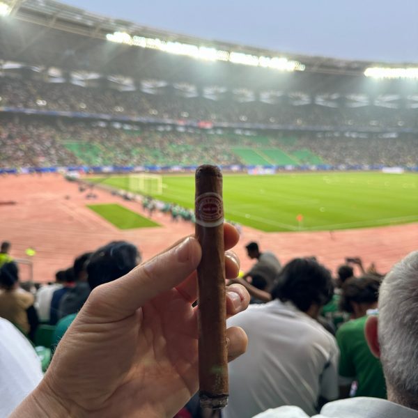 Cigar and spectators at stadium in Basra in Iraq. Iraq v Indonesia in Basra